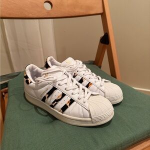 Adidas White Sneakers with Black and Gold Accents